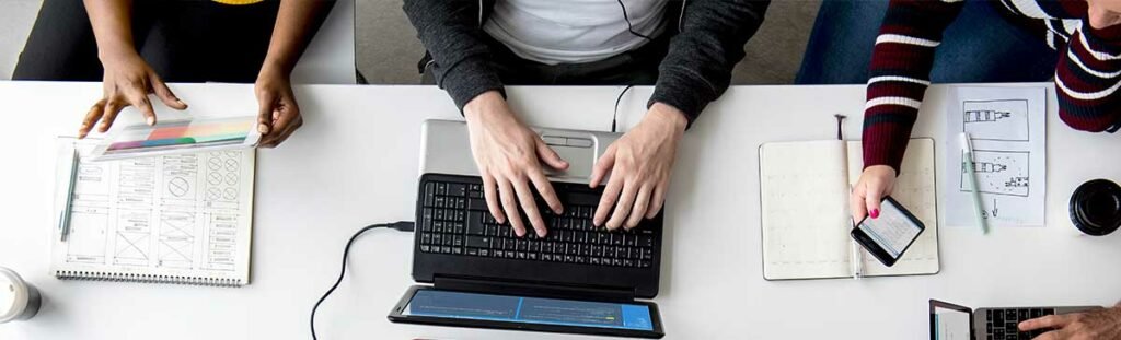 FAQs About Hiring A Digital Marketing Agency 2 Photo people hands working using laptop on white table